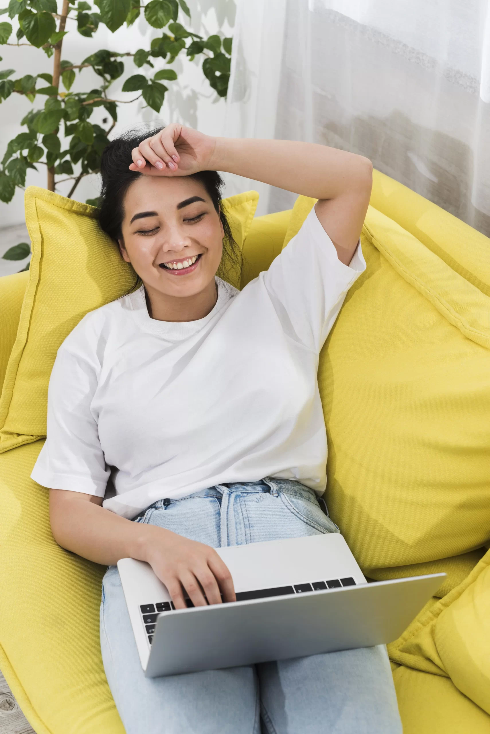 Services 15 high angle smiley woman home couch with laptop scaled
